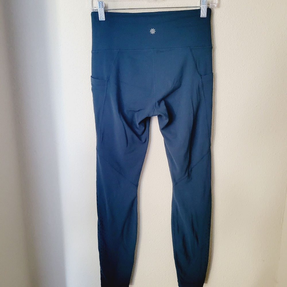 Athleta Stash Pocket Laser Cut Salutation Tight in Teal